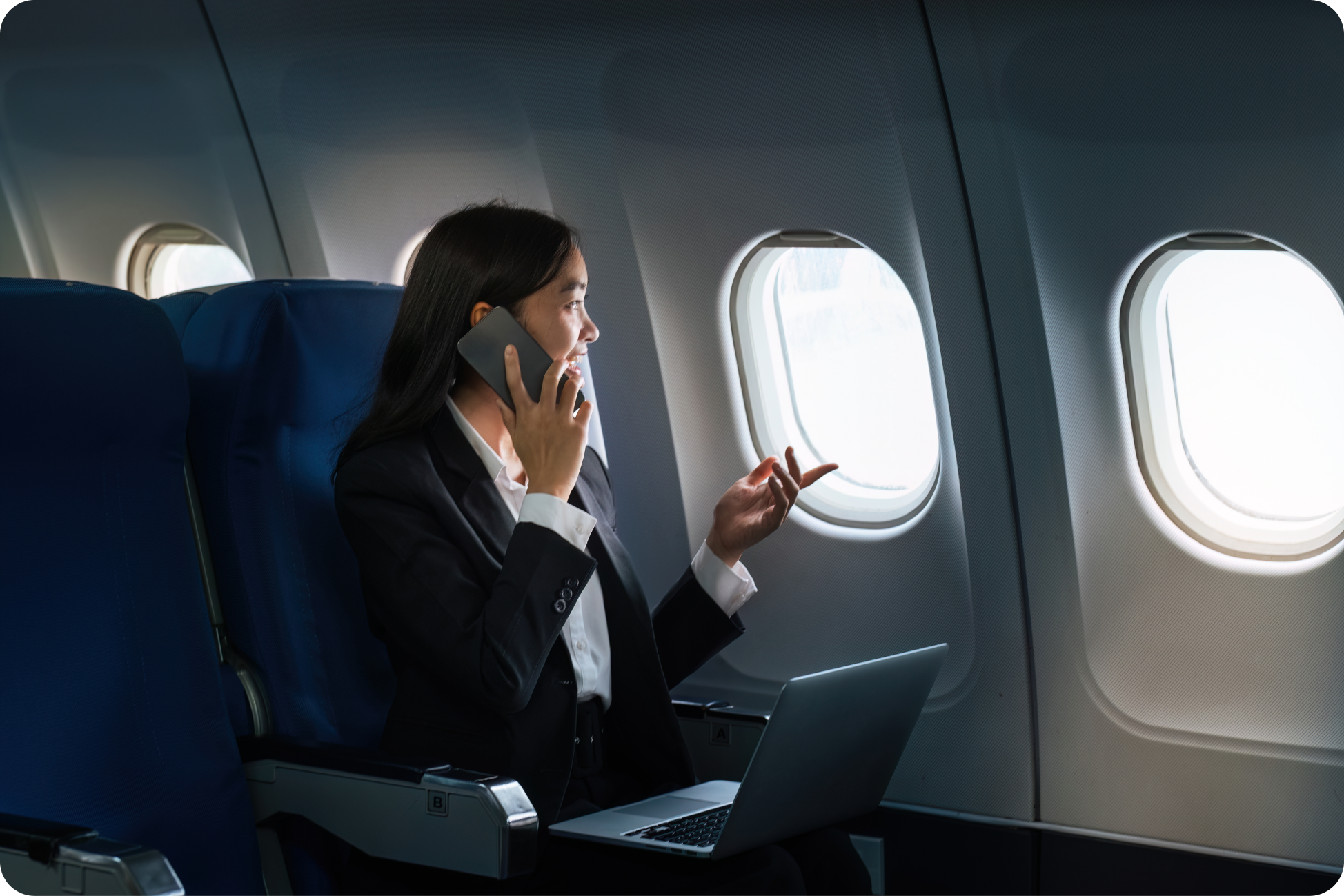 successful-asian-business-woman-business-woman-working-airplane-laptop-computer-looking-out-window-along-with-talking-phone.png